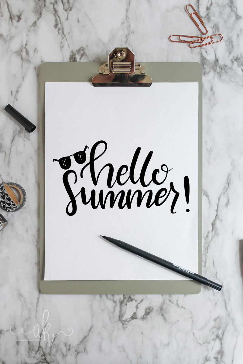 Hello Summer hand lettered on paper on a clip board with black and white accents