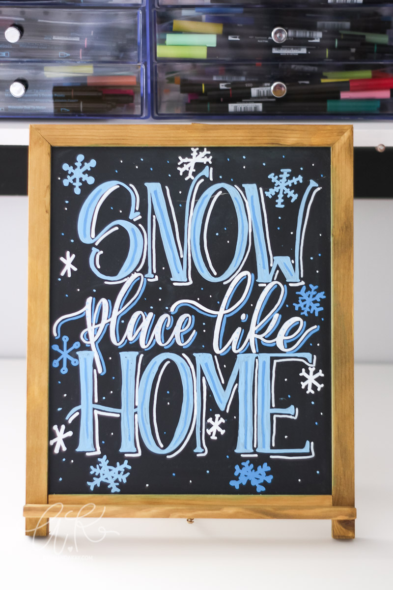 Snow place like home hand lettering on chalkboard